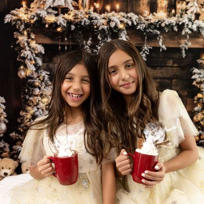 Two sisters with hot cocoa in a Christmas set